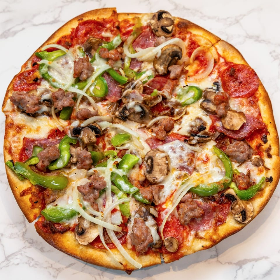 A DiCicco's Italian Restaurant pizza with pepperoni, sausage, mushrooms, green peppers, and onions.